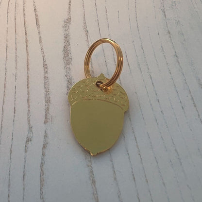 Brass Acorn Shape on Wood Background